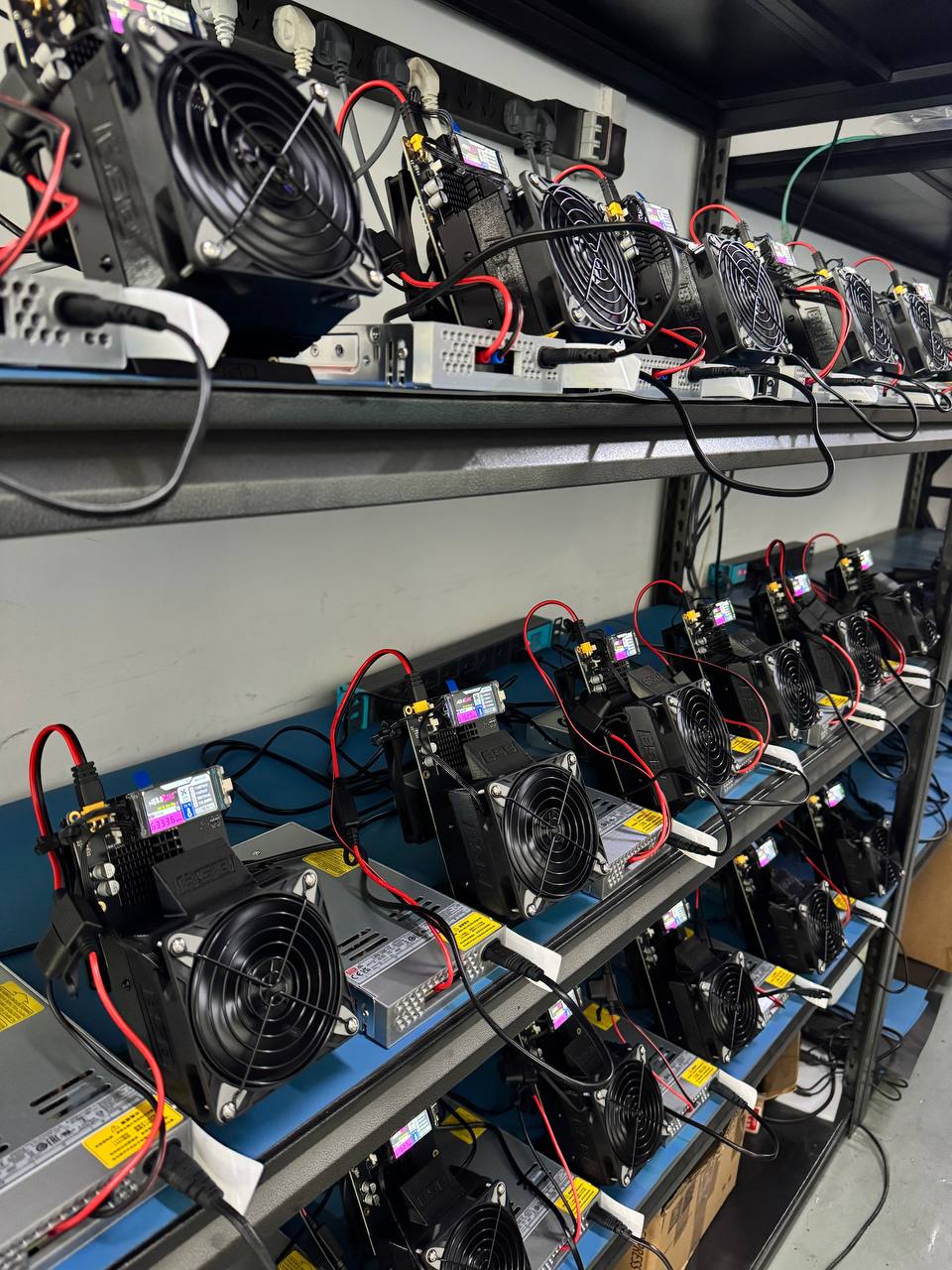 Production floor — every NerdQaxe++ paired with a Meanwell industrial PSU before ship